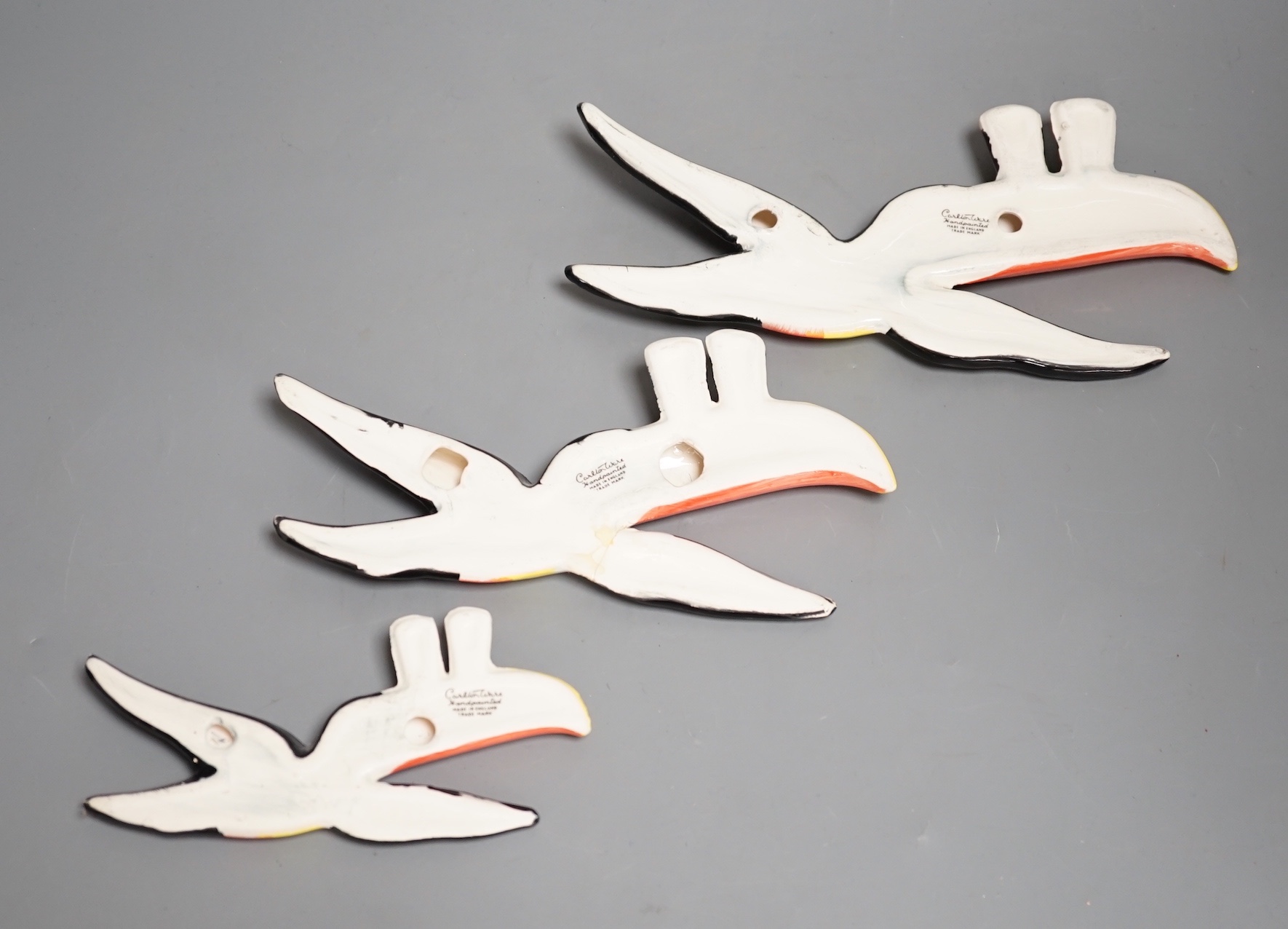A graduated set of three Carlton ware toucan wall plaques